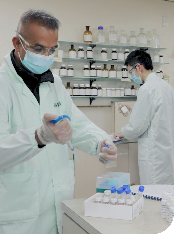 GMP laboratory staff preparing a blue sample